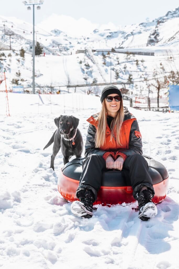 full shot woman sitting outdoors with dog